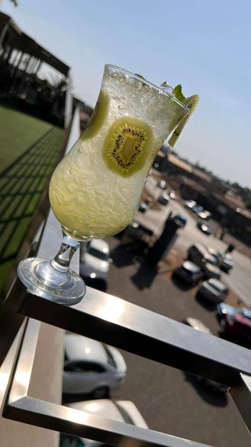 Kiwi mocktail on the railing