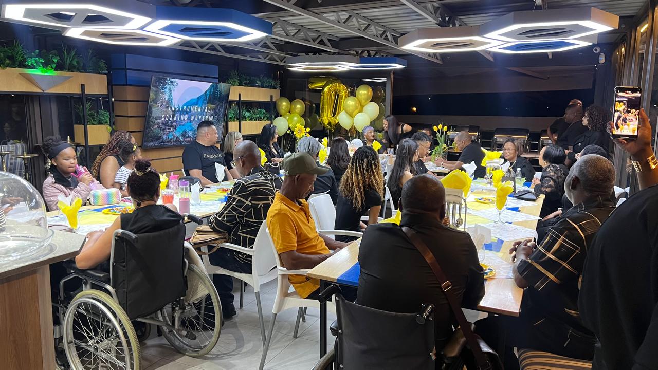 70th birthday guests dining indoors