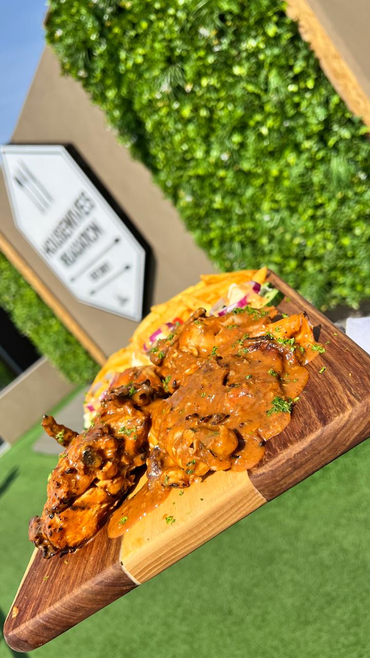 Saucy chicken on wooden board